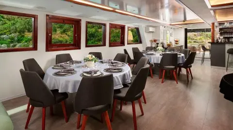 Lupus Mare luxury yacht dining area at sunset with table settings