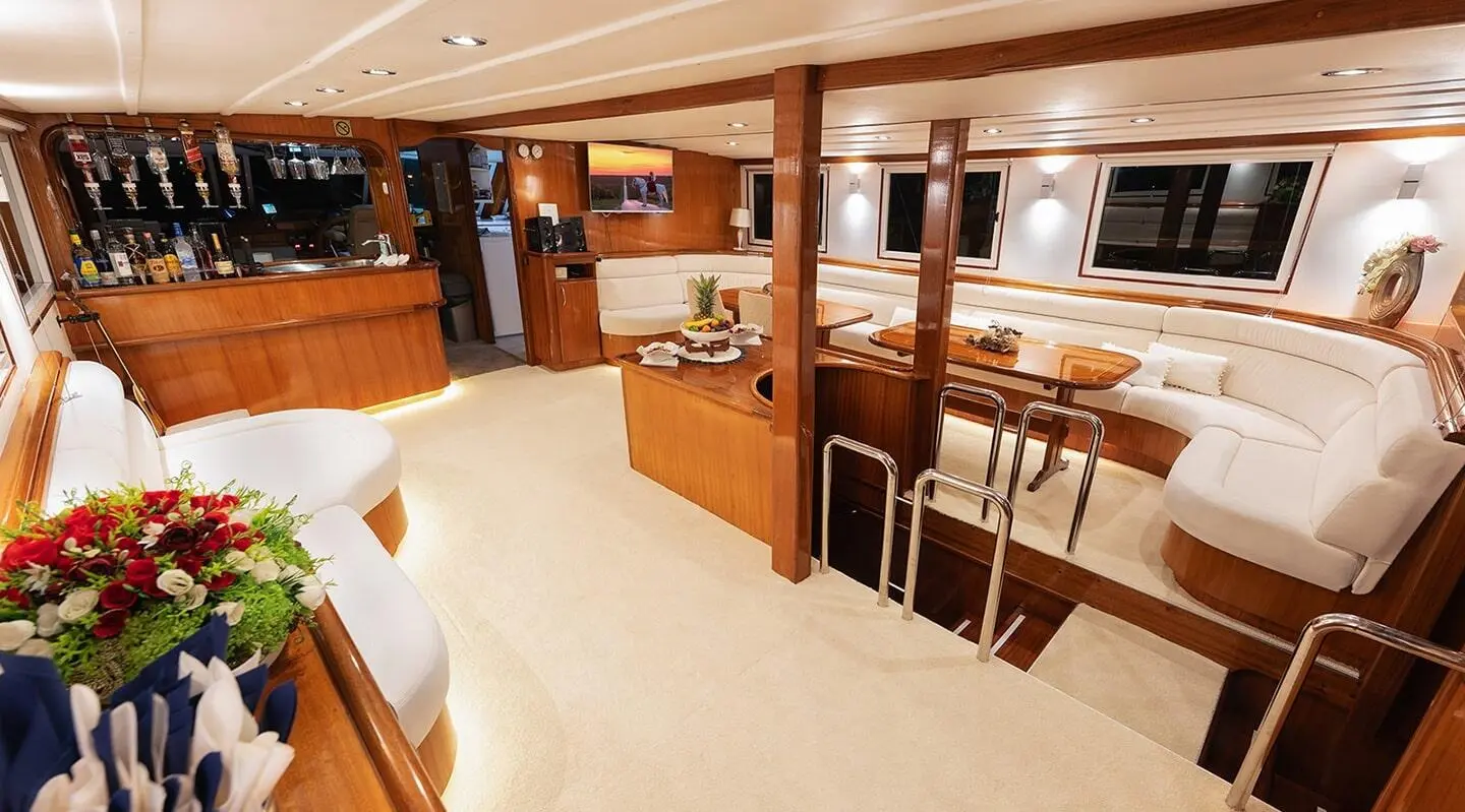A spacious yacht salon aboard Aurum with wooden furnishings and seating