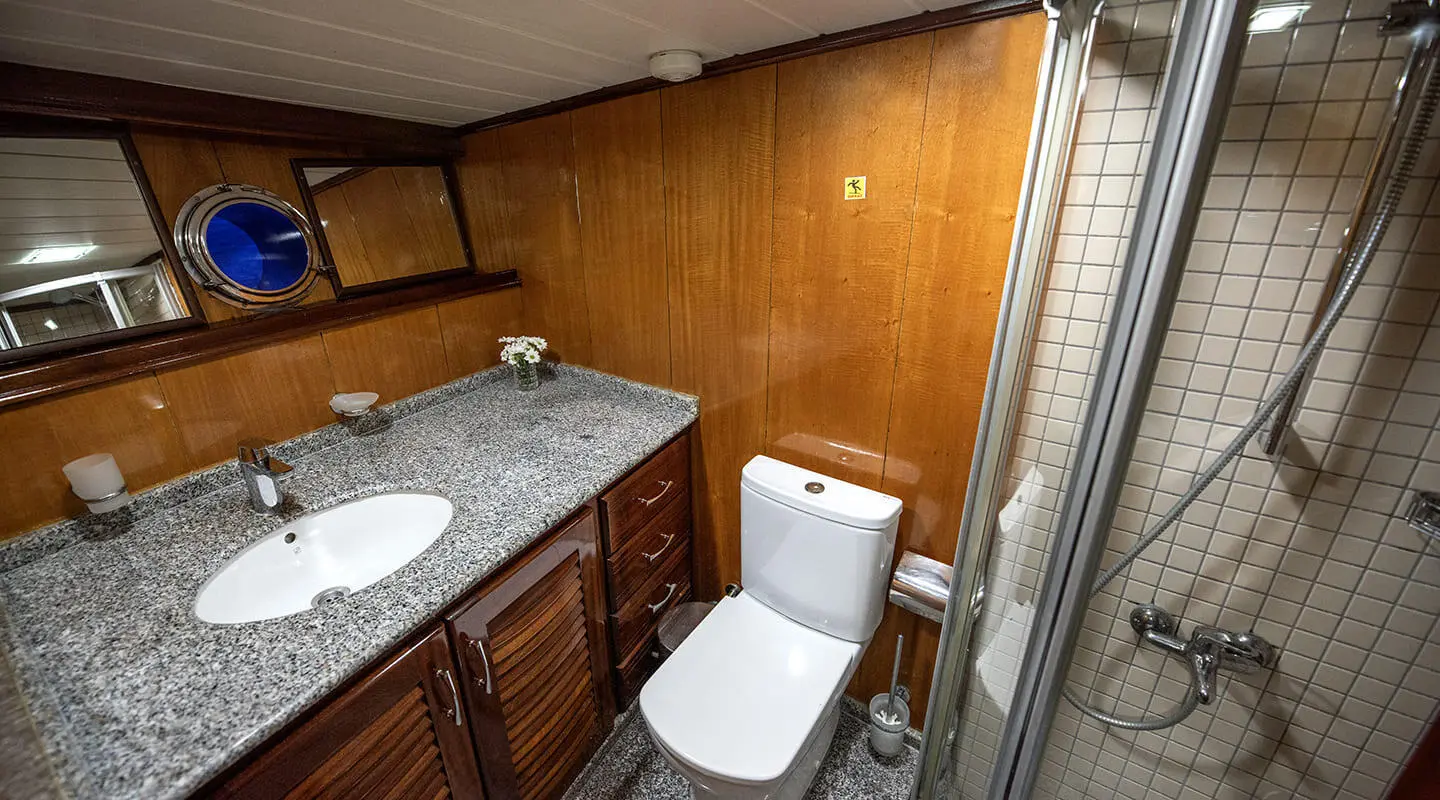 Kayhan 8 yacht interior bathroom with dual sinks, wooden cabinets, and toilet