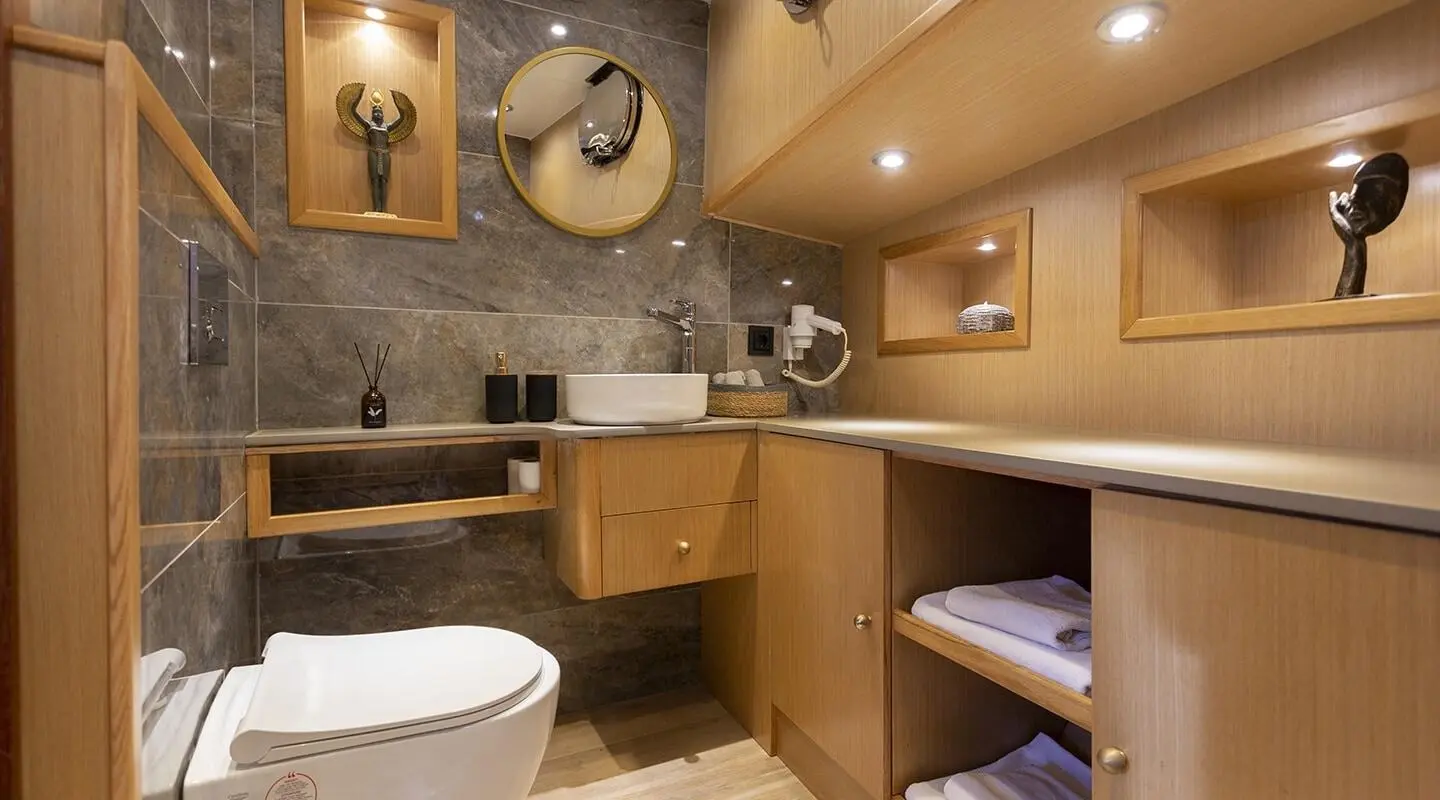 Bathroom on Diva Deniz yacht with wooden vanity, sink, and mirror
