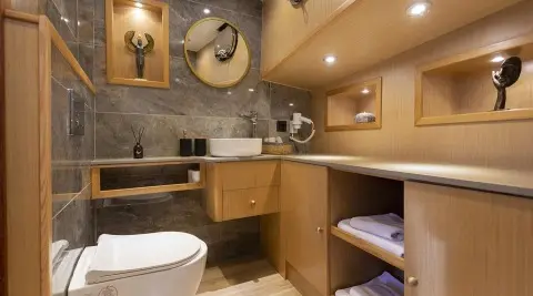 Bathroom on Diva Deniz yacht with wooden vanity, sink, and mirror