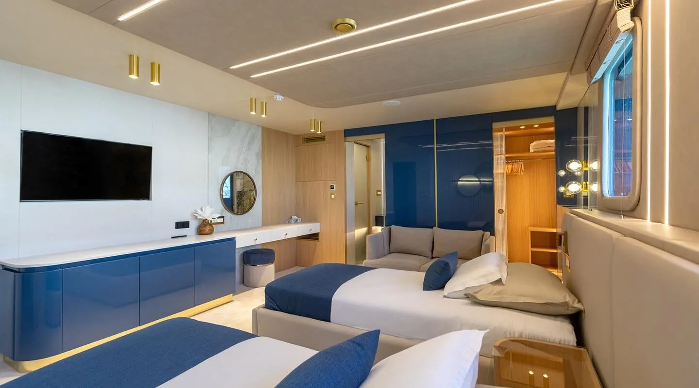Interior of Scorpios luxury yacht bedroom with white and blue bedding
