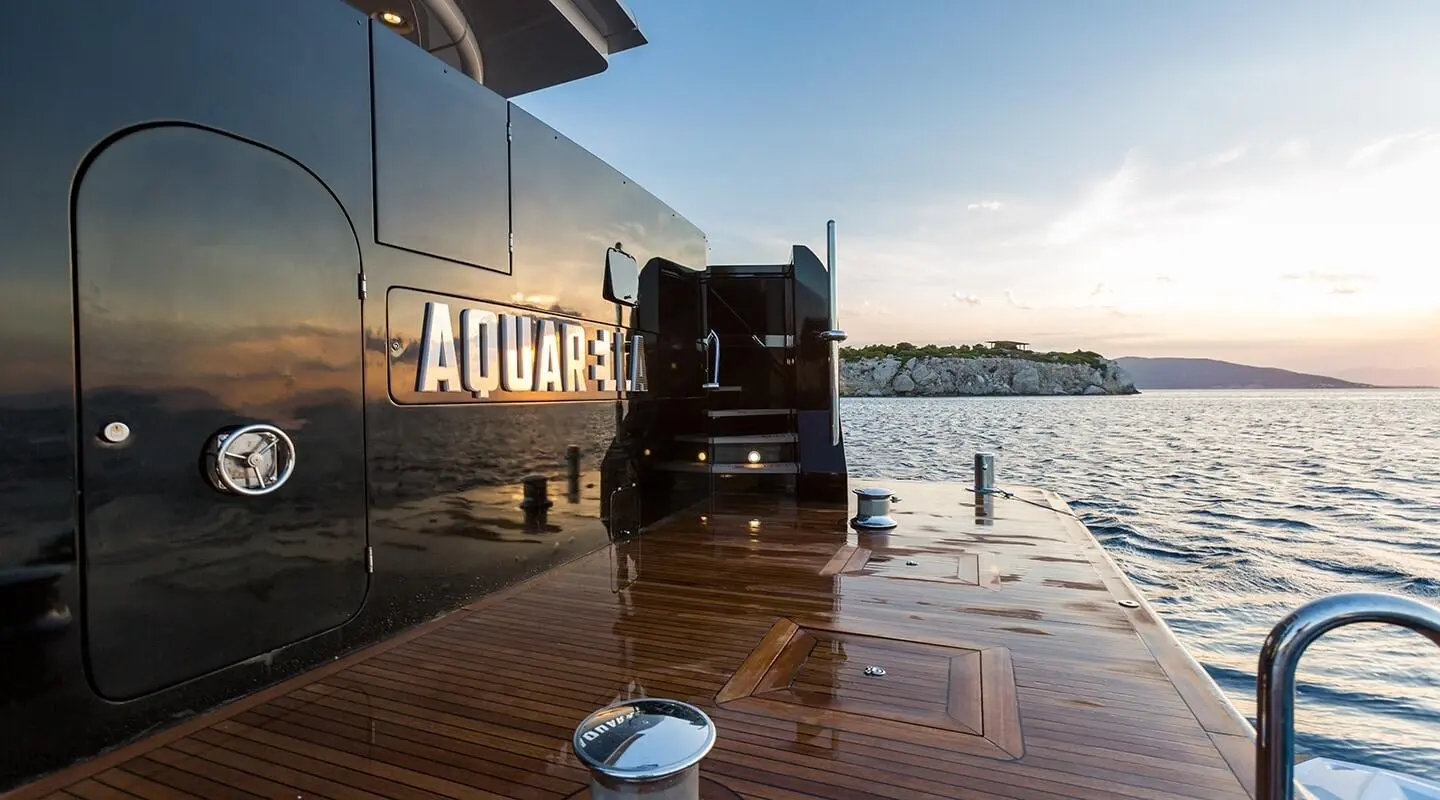 Aquarella yacht docked at sunset with wooden pier and calm water
