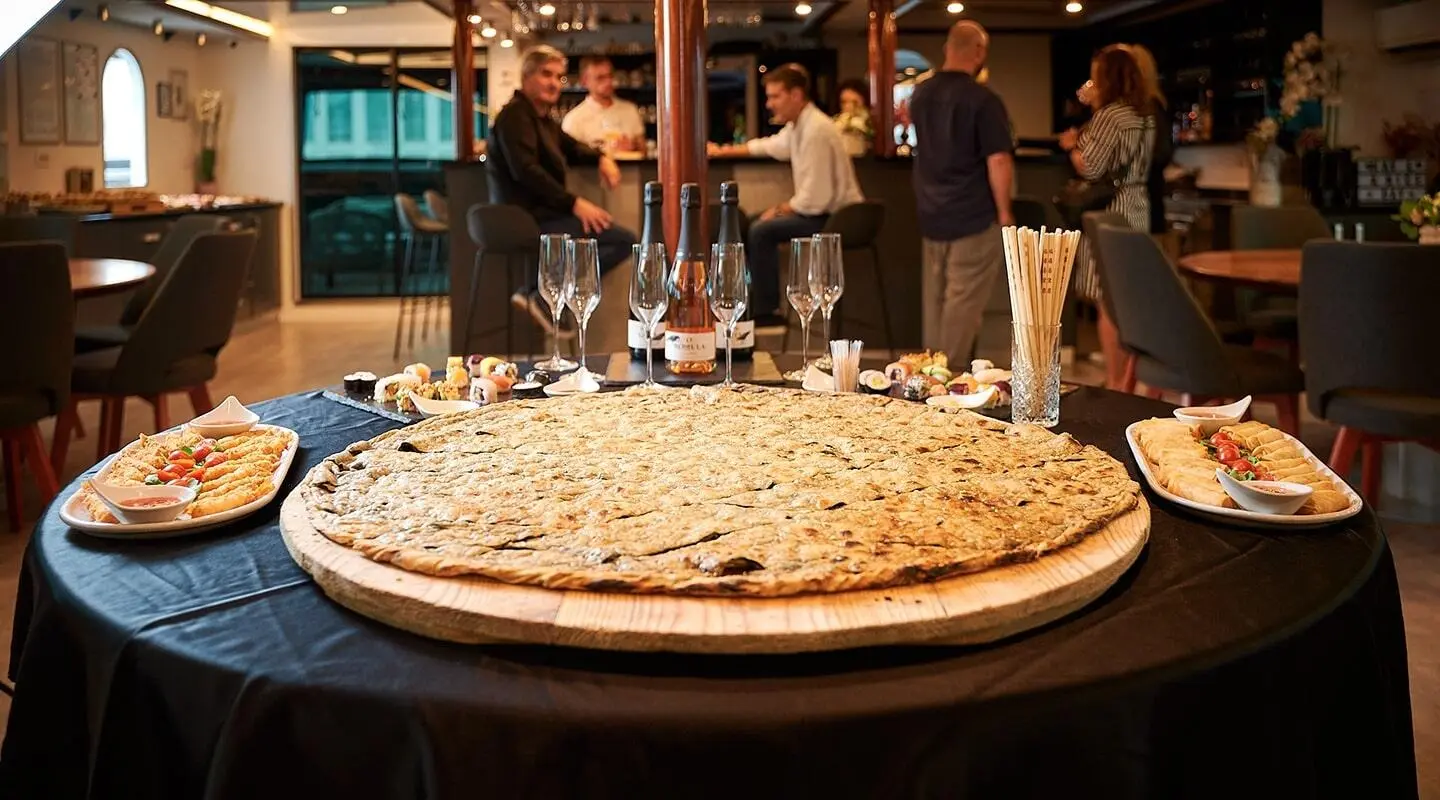Lupus Mare 42m exterior yacht deck with guests gathering around a large pizza