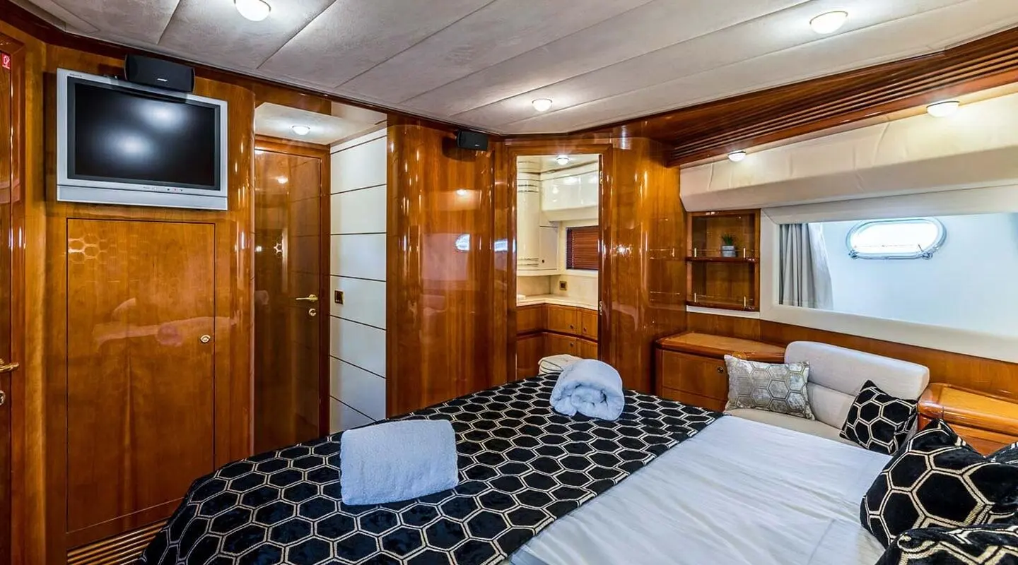 Luxurious wooden cabin with wardrobe doors and a TV mounted on the wall