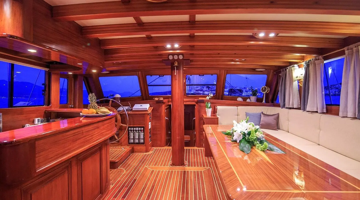 Carpe Diem 7 yacht interior on a wooden deck with seating and blue evening lighting