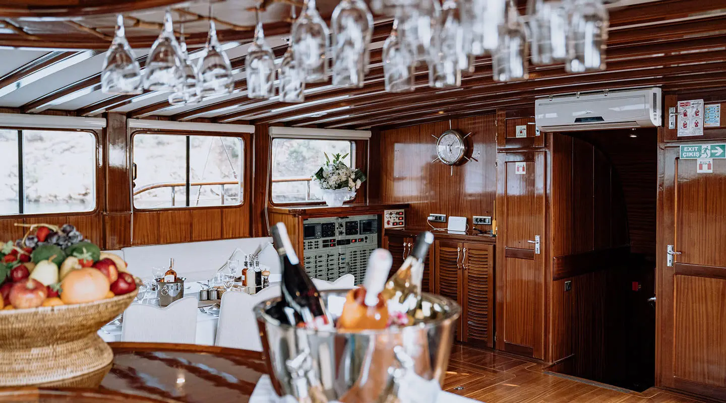 Lycian Queen luxury gulet at sunset with polished wood interior and bar seating