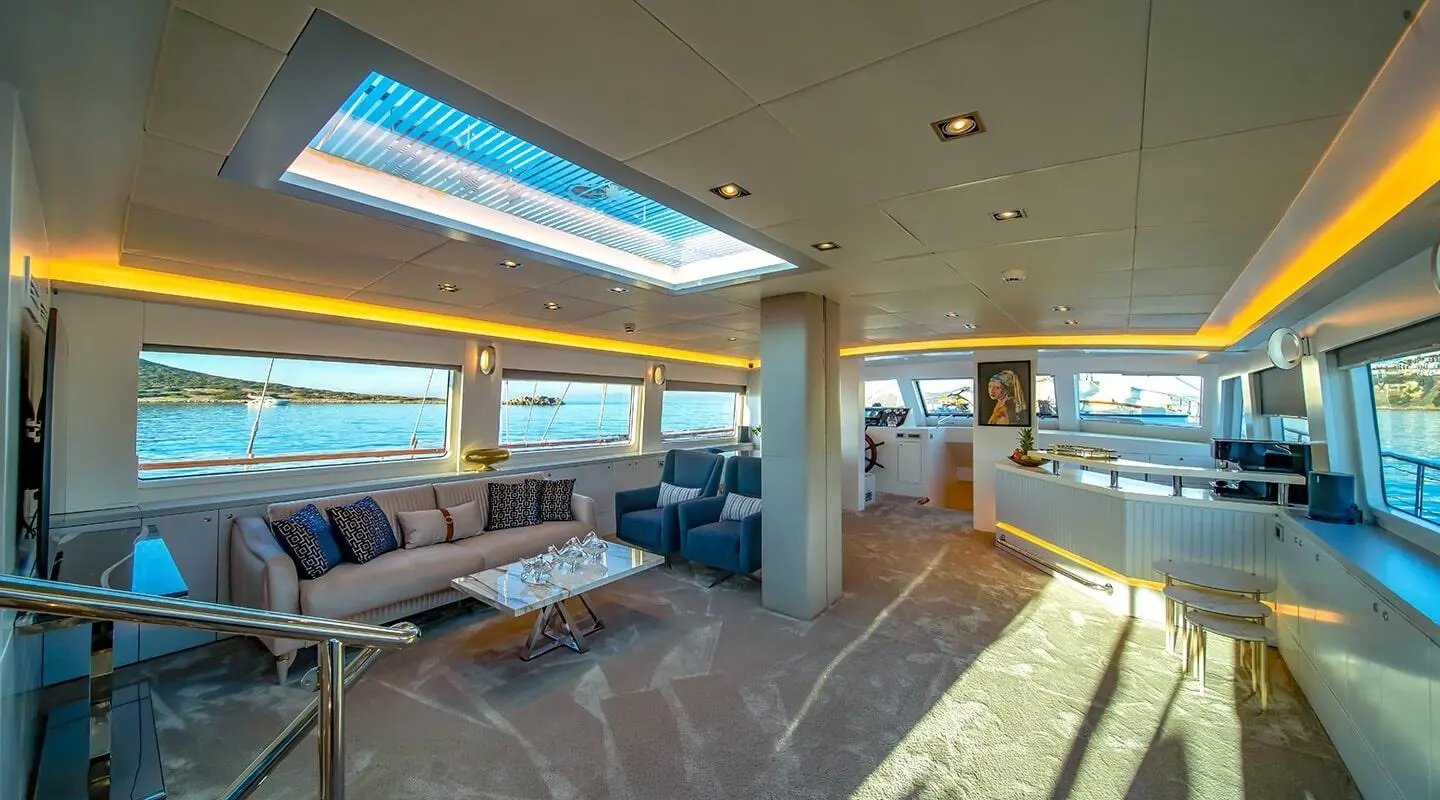 Interior of gulet Double Eagle yacht saloon with large windows and seating