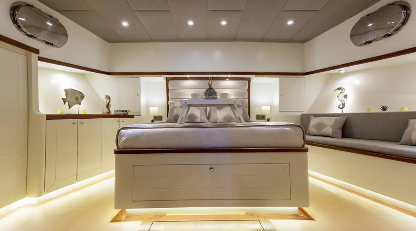 Luxurious yacht interior with curved sofa, dining area, and overhead lighting on Grand Sailor