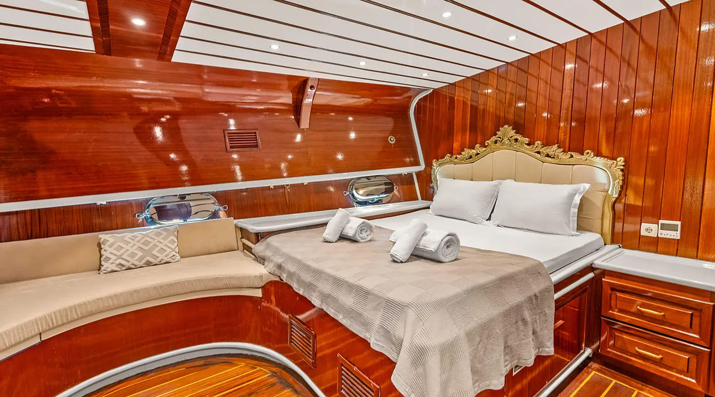 Esma Sultan luxury yacht interior with cushioned benches and wood paneling at sunset