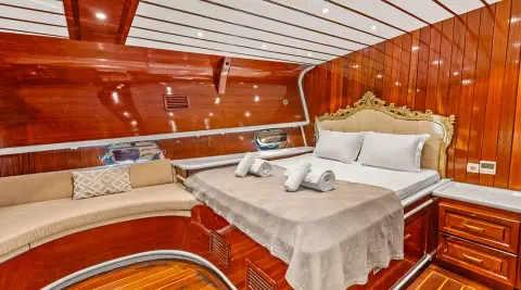 Esma Sultan luxury yacht interior with cushioned benches and wood paneling at sunset