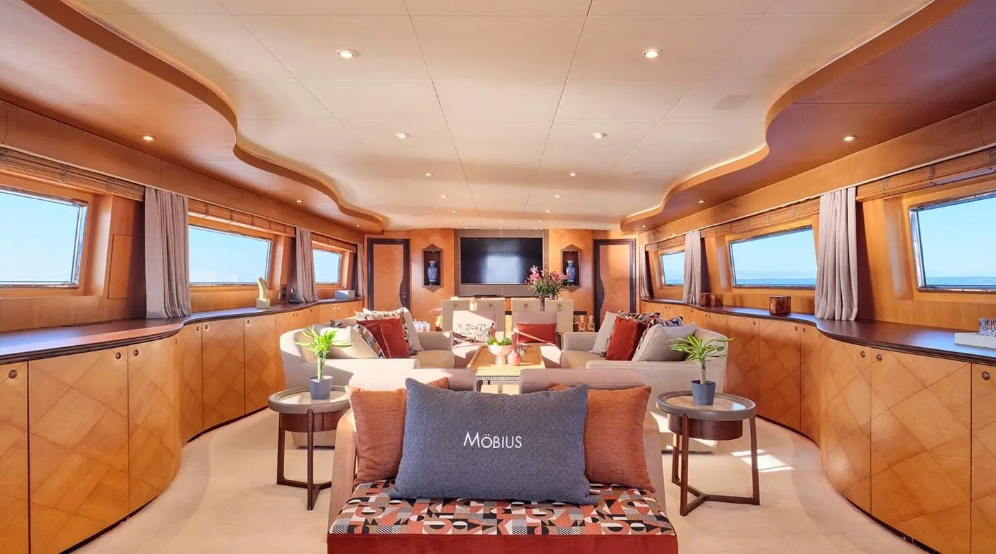 Luxurious yacht Mobius salon interior with beige seating and wood accents