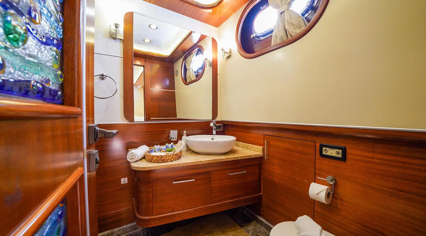 Luxurious interior of La Bella Vita yacht with wooden cabinetry and porthole