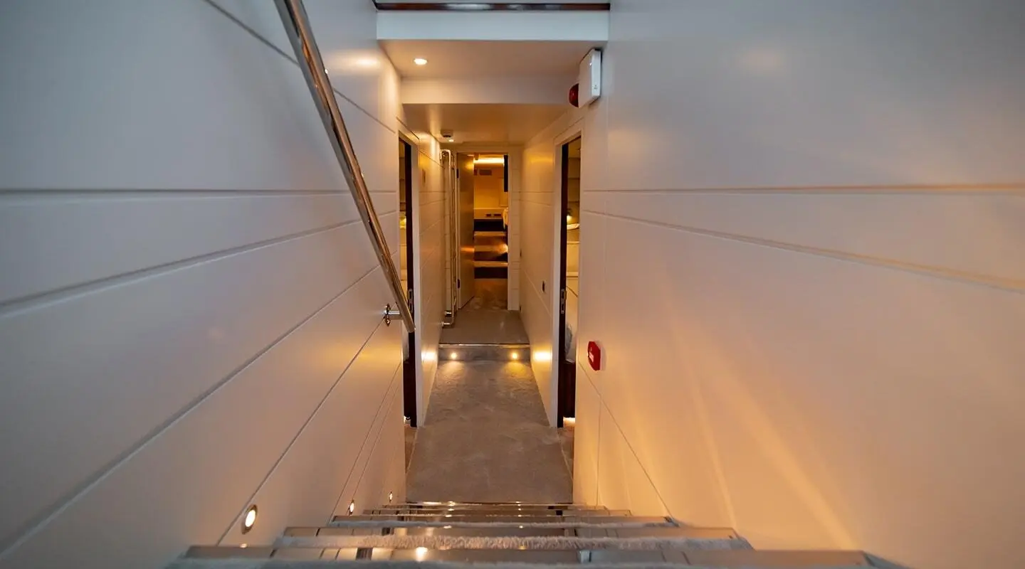 Evening view of a yacht gangway leading to a lit doorway on Double Eagle