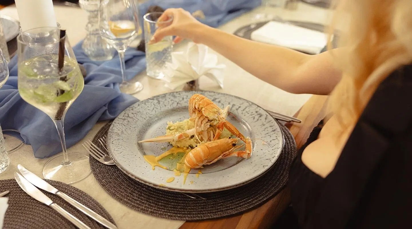 Bella yacht dining at sea with plated appetizers on a circular plate