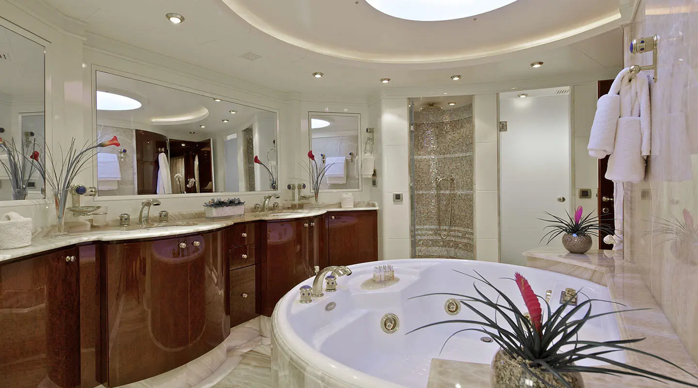 O'Rion luxury yacht bathroom with circular tub and modern vanity mirrors