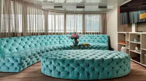 Ohana yacht deck saloon with turquoise tufted seating and large windows