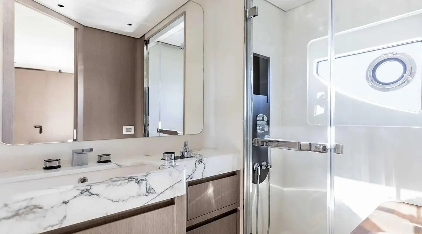 Viva II yacht bathroom with marble countertop, sink, and shower area visible