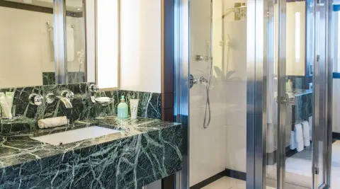 Alalya luxury yacht, elegant bathroom with green marble countertop and glass shower