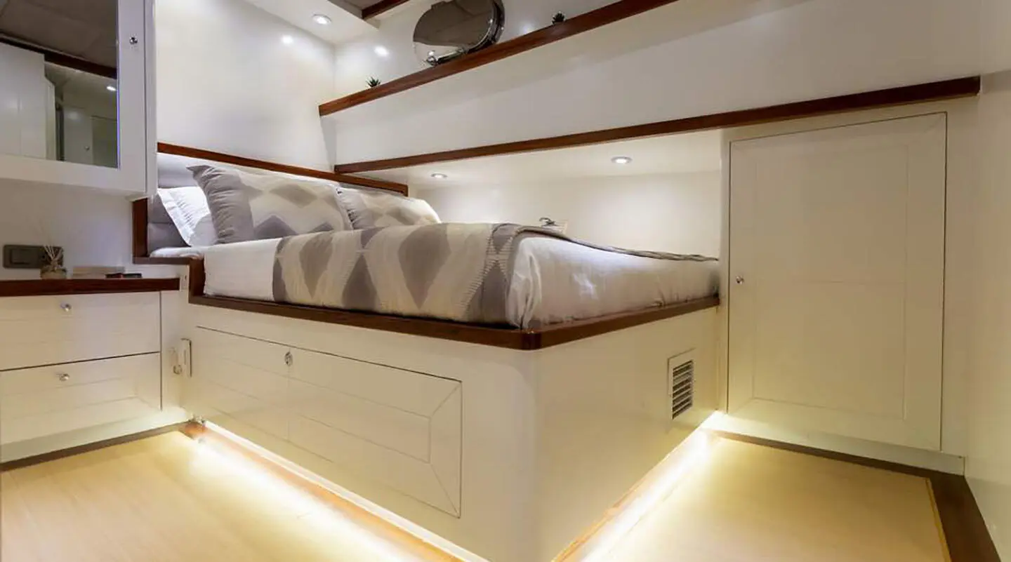 Interior of Grand Sailor gulet with double cabin, bed, porthole, and storage.