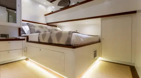 Interior of Grand Sailor gulet with double cabin, bed, porthole, and storage.
