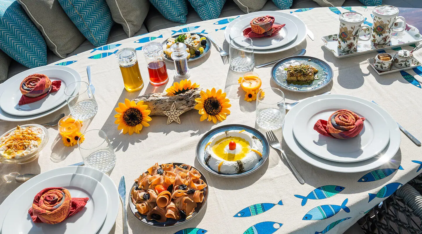 Amadea yacht dining table set for charter with sunflowers and seafood starters