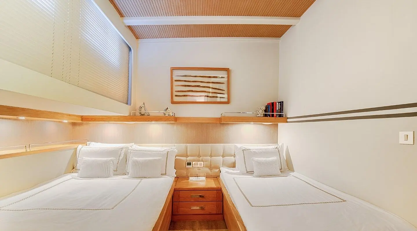 Cobra King luxury sailing yacht interior with white cushions and wooden steps