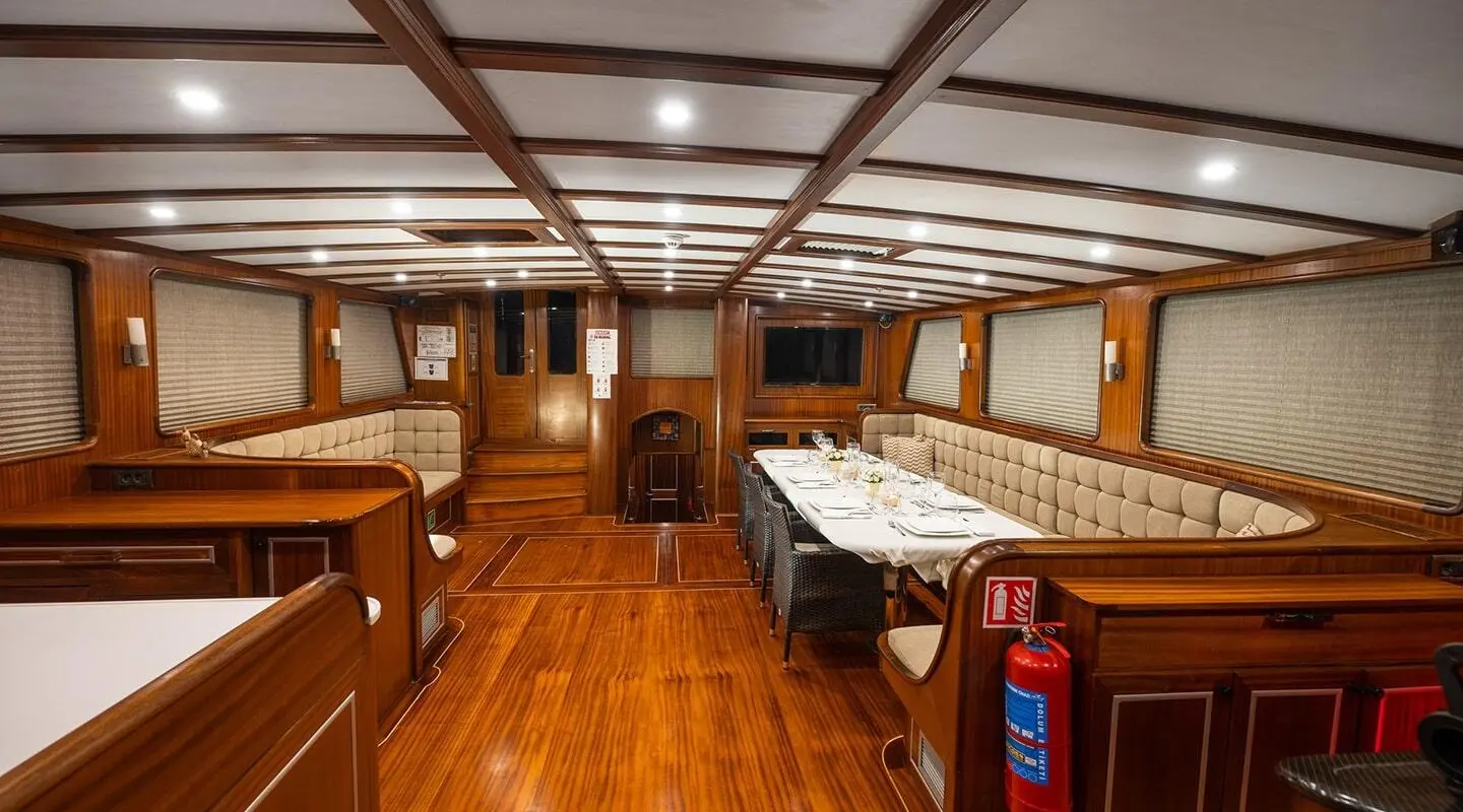 Gulet Estrella De Mar sailing yacht saloon with wooden flooring and dining table