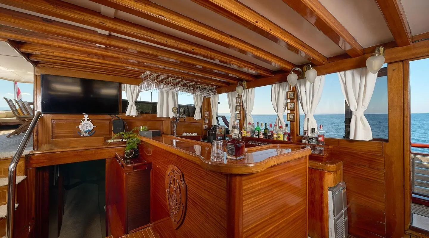 Wooden bar area inside Linda yacht with sea view