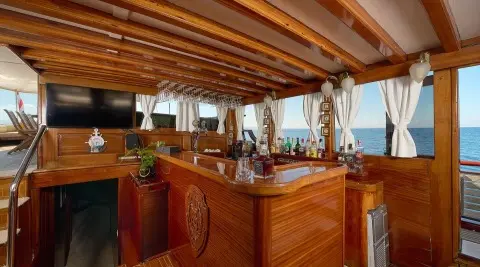 Wooden bar area inside Linda yacht with sea view