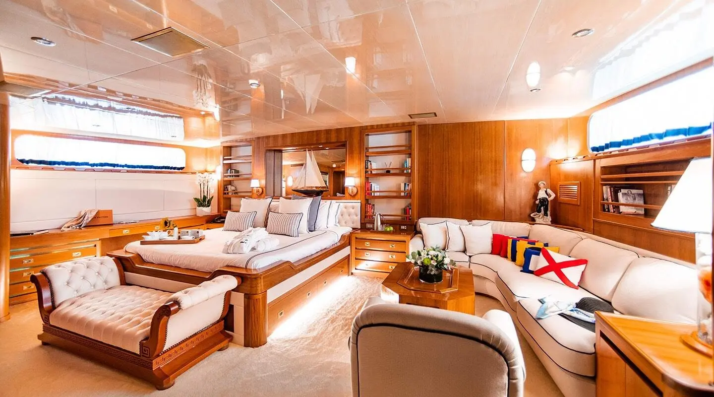 Interior of Wind Of Fortune yacht lounge with seating, wood paneling, and warm lighting