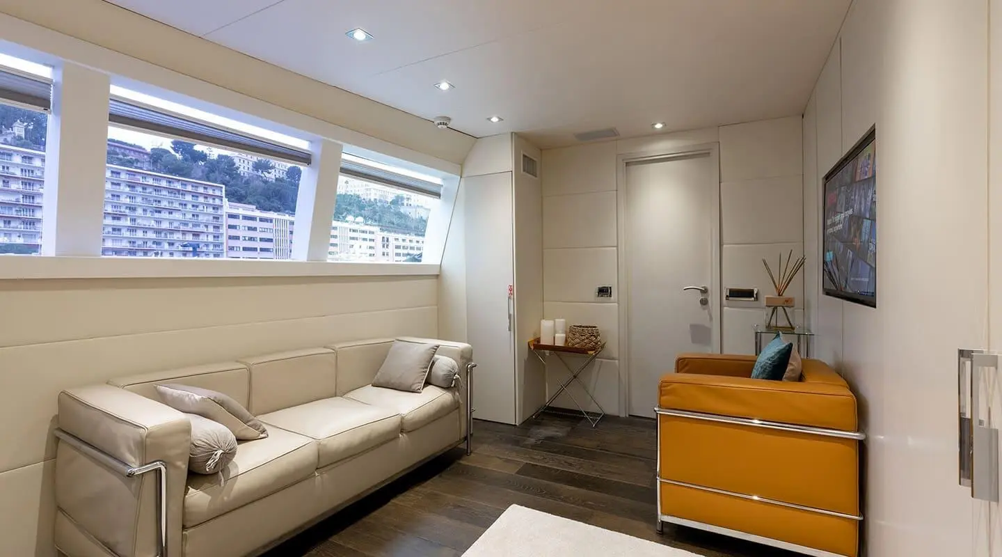 Yacht Brooklyn interior: white sofa, wood floor, light cabinets, beige walls