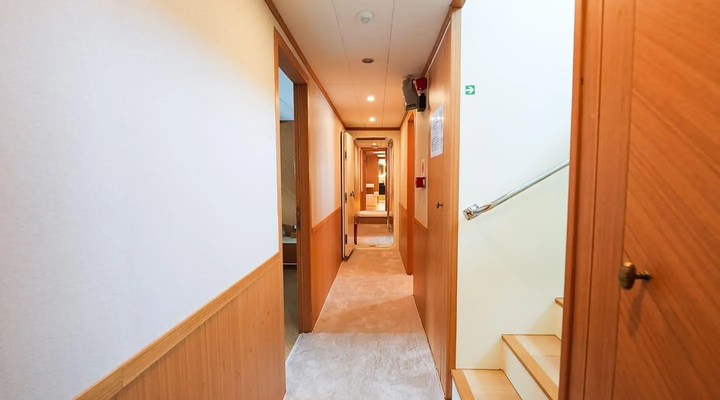 55m luxury corridor on King Of The Sea yacht interior with wood paneling and soft lighting