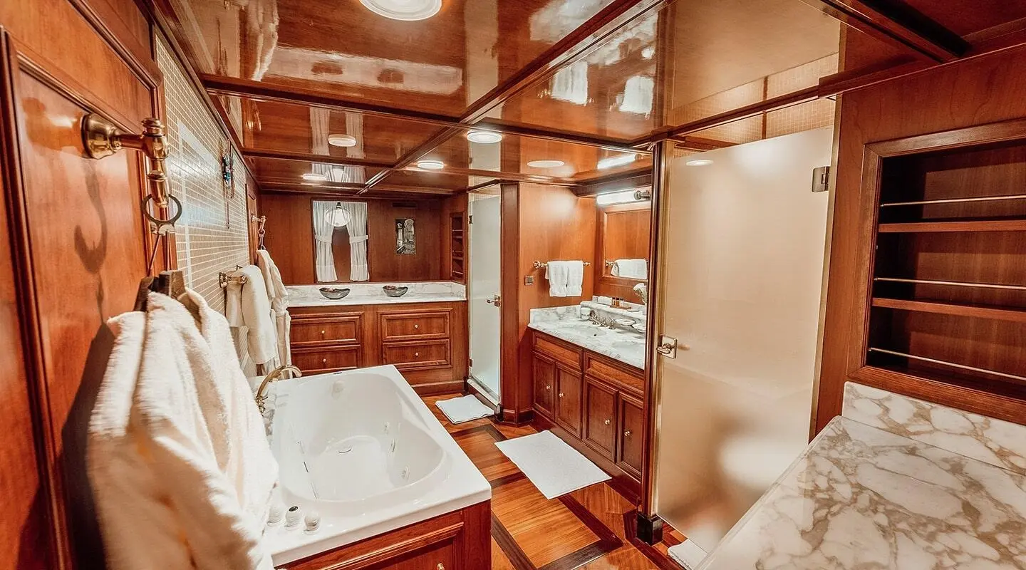 Seagull II yacht interior with wooden paneling, cabin beds, and compact seating area