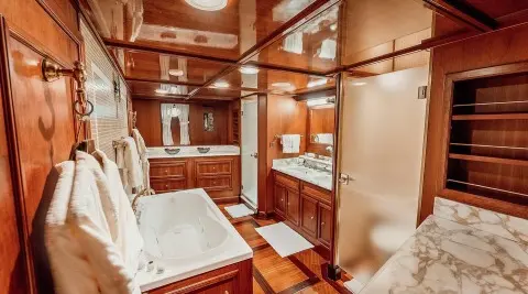 Seagull II yacht interior with wooden paneling, cabin beds, and compact seating area