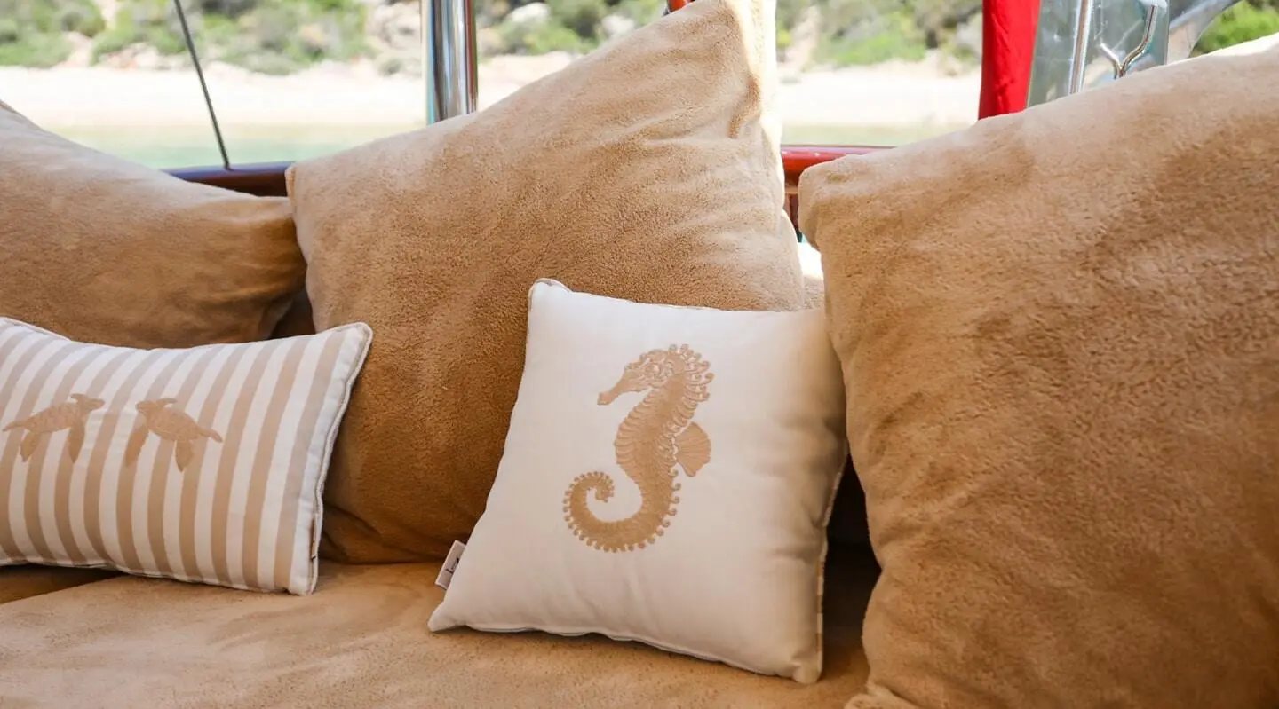 Ulucinar luxury gulet at sunset with cushioned seating on deck and pillows
