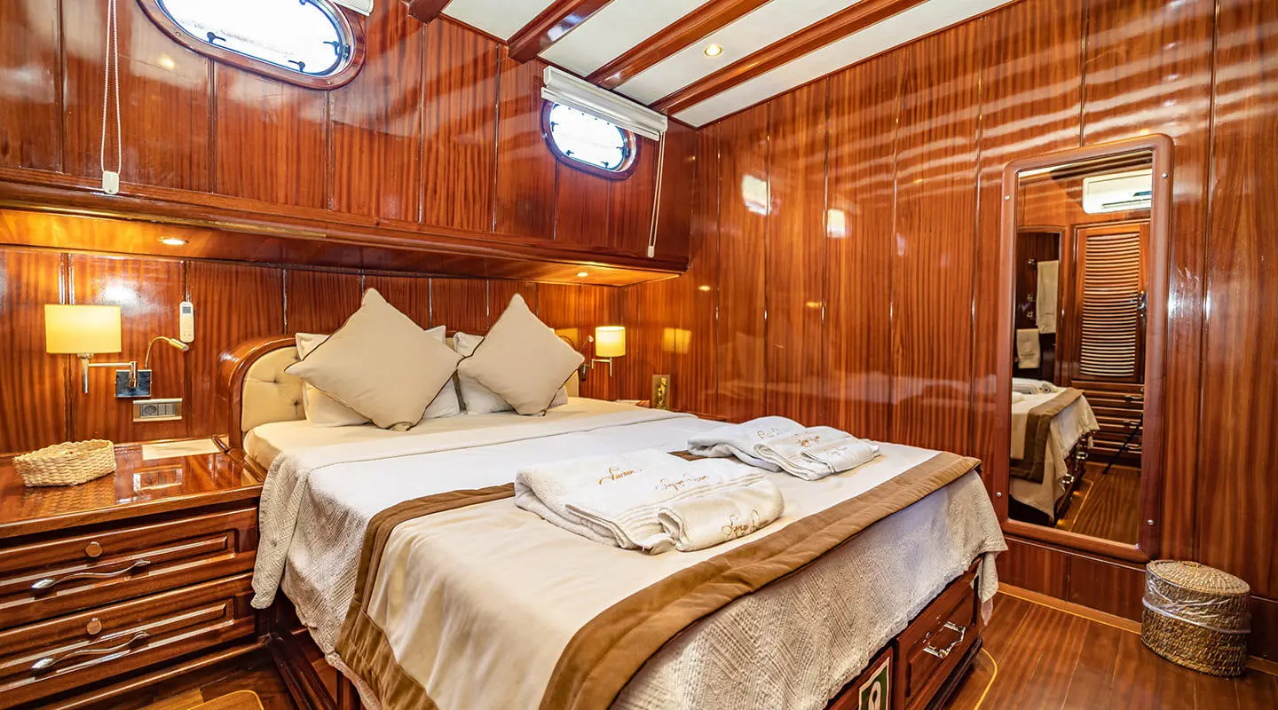 Lycian Queen luxury gulet interior: two bed cabins with beige bedding and wood paneling