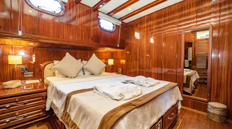 Lycian Queen luxury gulet interior: two bed cabins with beige bedding and wood paneling
