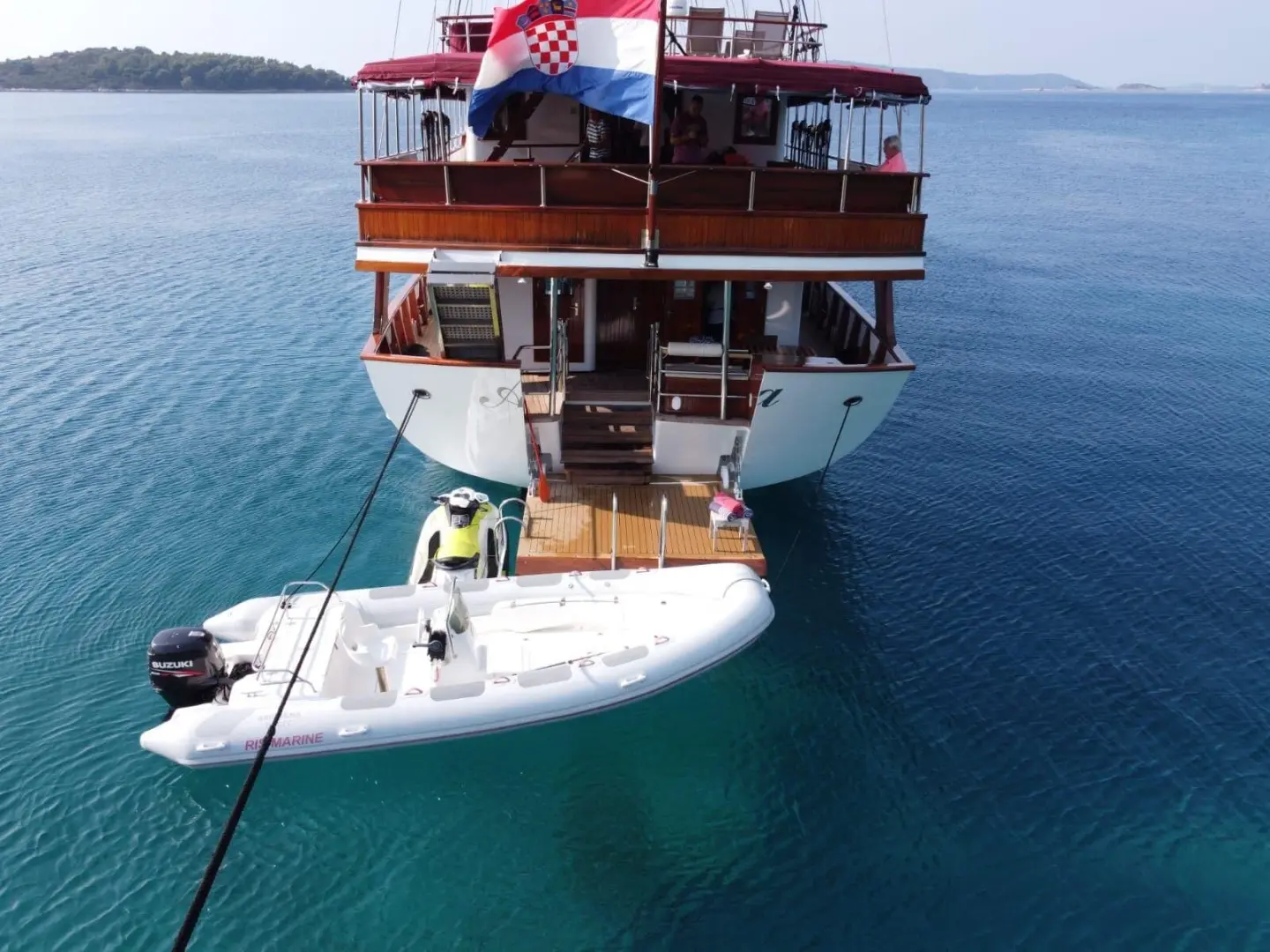 Amorena motor yacht seen from above, docked with a swim platform at stern