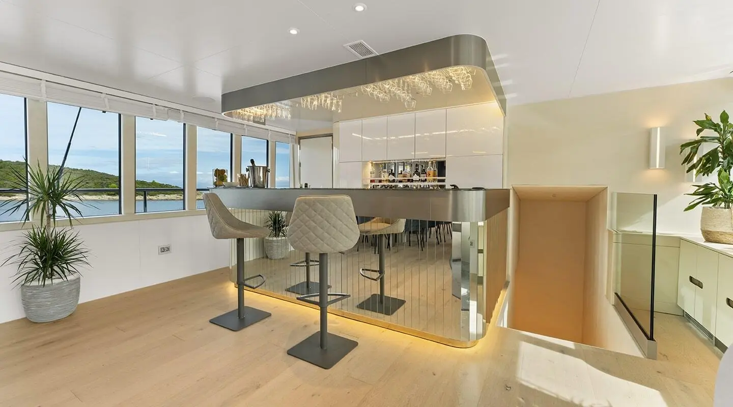 Luxurious yacht salon bar on Maxita with stools and panoramic windows