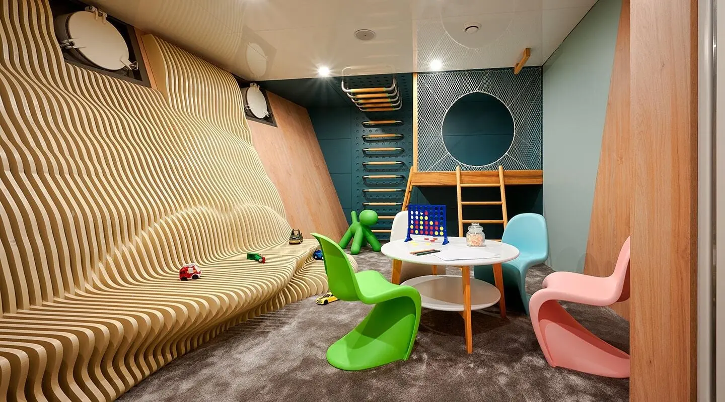 Interior of Ohana yacht with playful playroom, seating, bright colors, and stairs