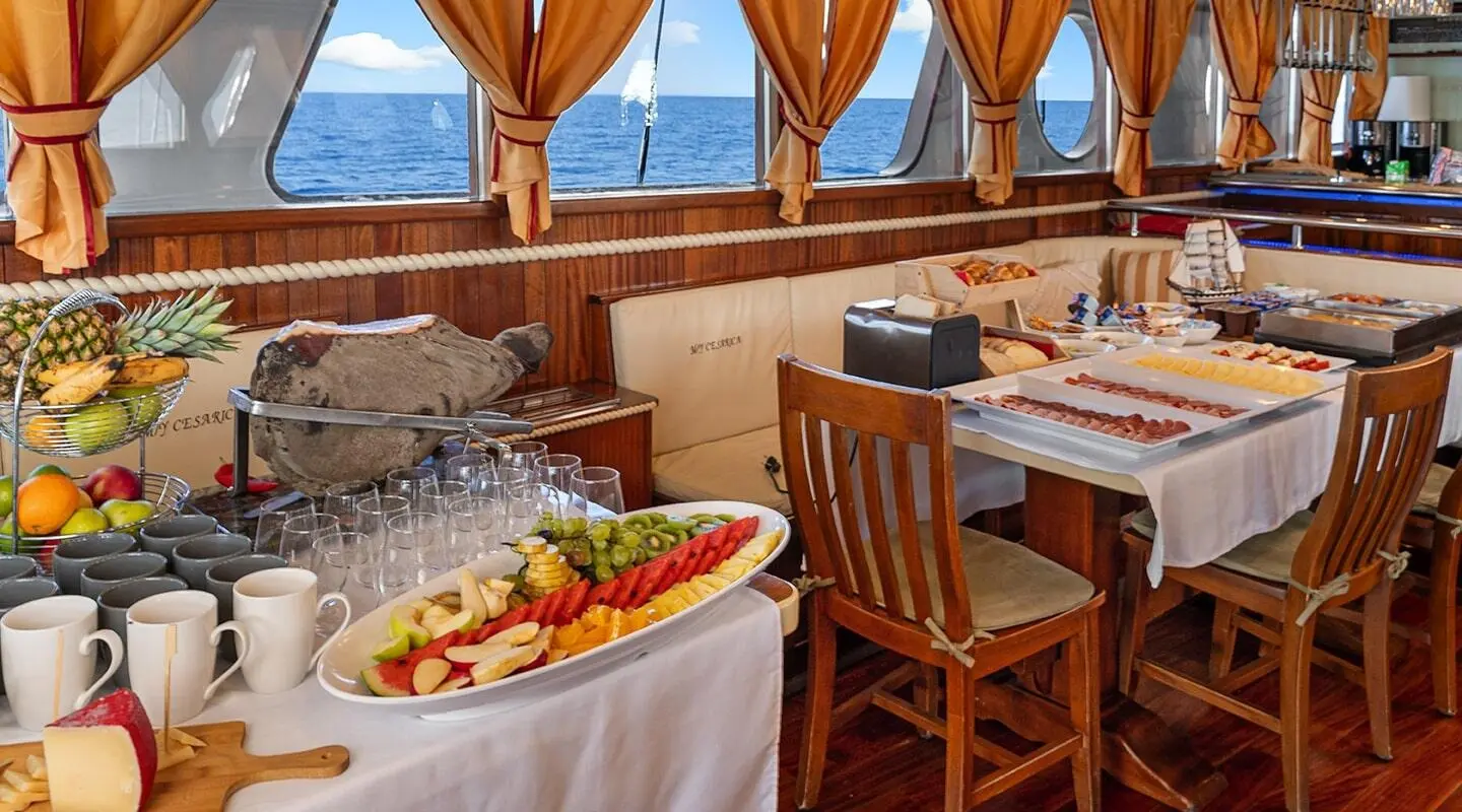 Cesarica luxury gulet sailing yacht deck at sunset with tables and chairs