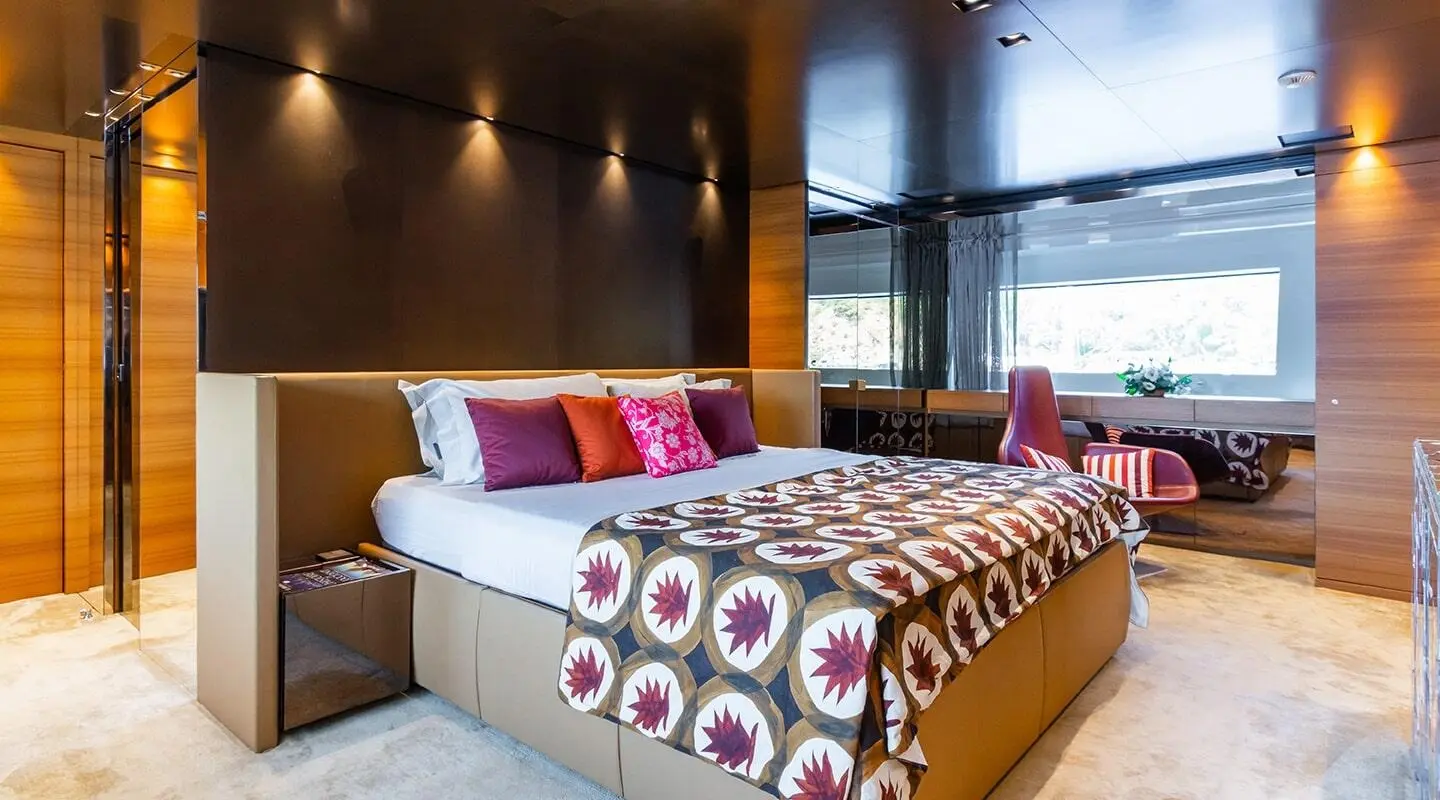 Takara One luxury yacht master cabin with large bed and decorative pillows