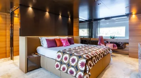 Takara One luxury yacht master cabin with large bed and decorative pillows