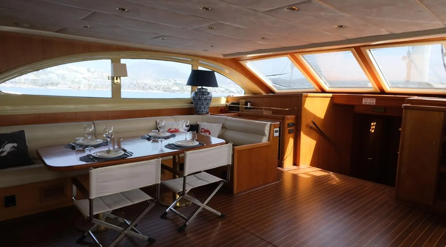 Interior stern lounge of Queen Of Sea gulet with wooden deck and seating