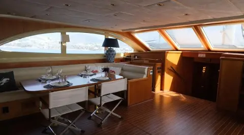Interior stern lounge of Queen Of Sea gulet with wooden deck and seating