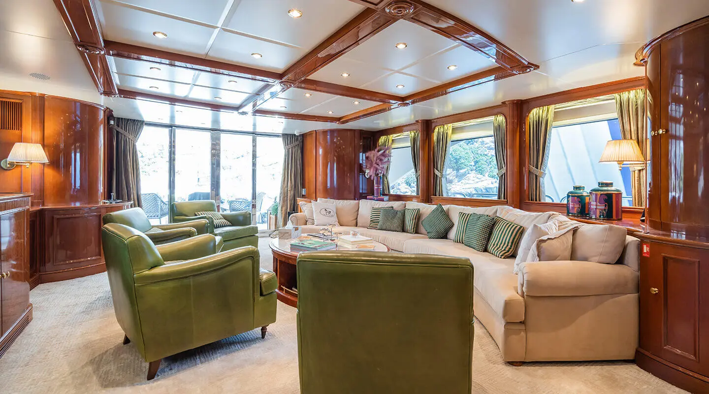 Interior of Amadea yacht with plush green seating and large windows