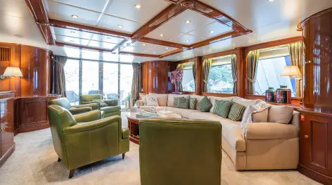 Interior of Amadea yacht with plush green seating and large windows