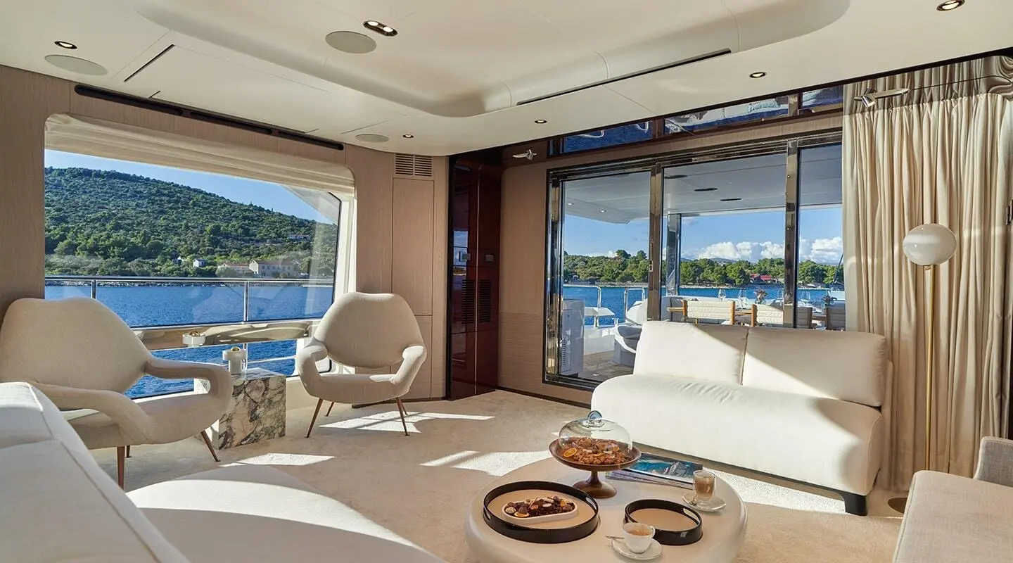 Aluminia Too luxury yacht salon at sunset with sofa seating and glass doors