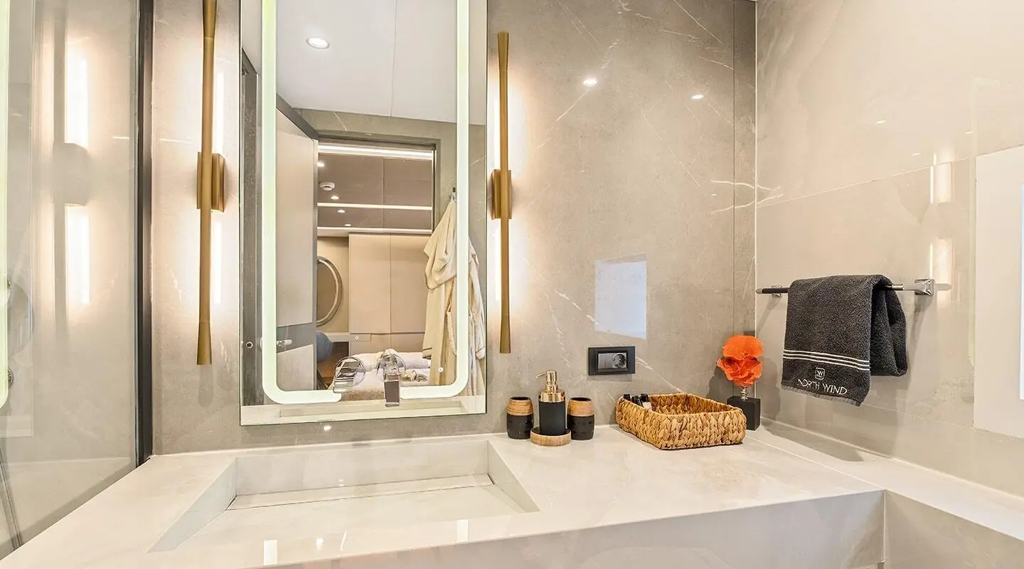 North Wind luxury yacht bathroom with sink, mirror, and counter clutter